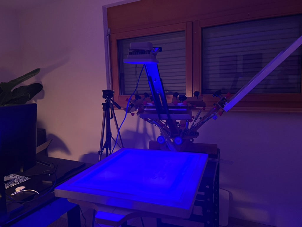 A screenprinting frame illuminated in blue in the 1800m Club studio