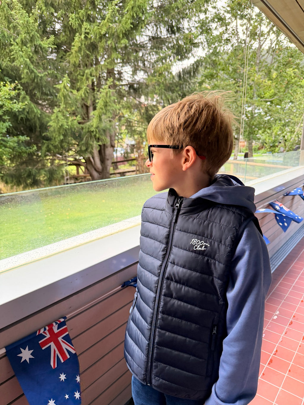Child wearing the 1800m Club French Navy padded vest outdoors