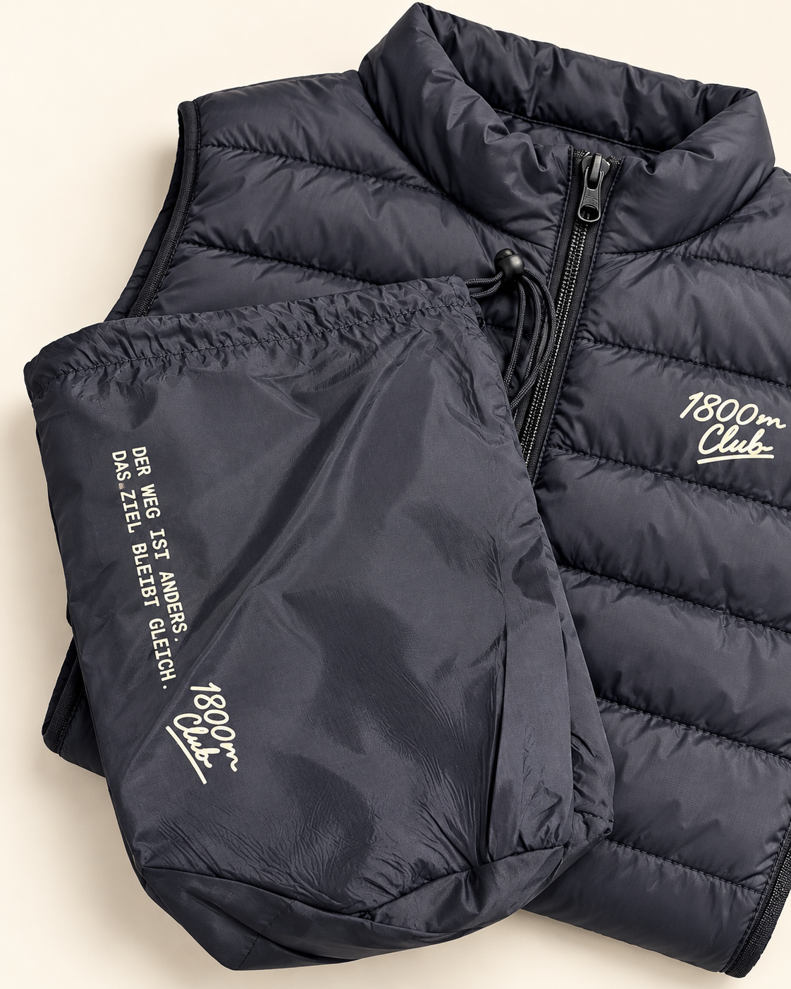 Studio detail of the 1800m Club French Navy kids padded vest and pack-away bag