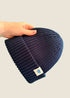 Navy blue ribbed kids’ beanie with cream 1800m Club label. Made in Arosa, Switzerland.