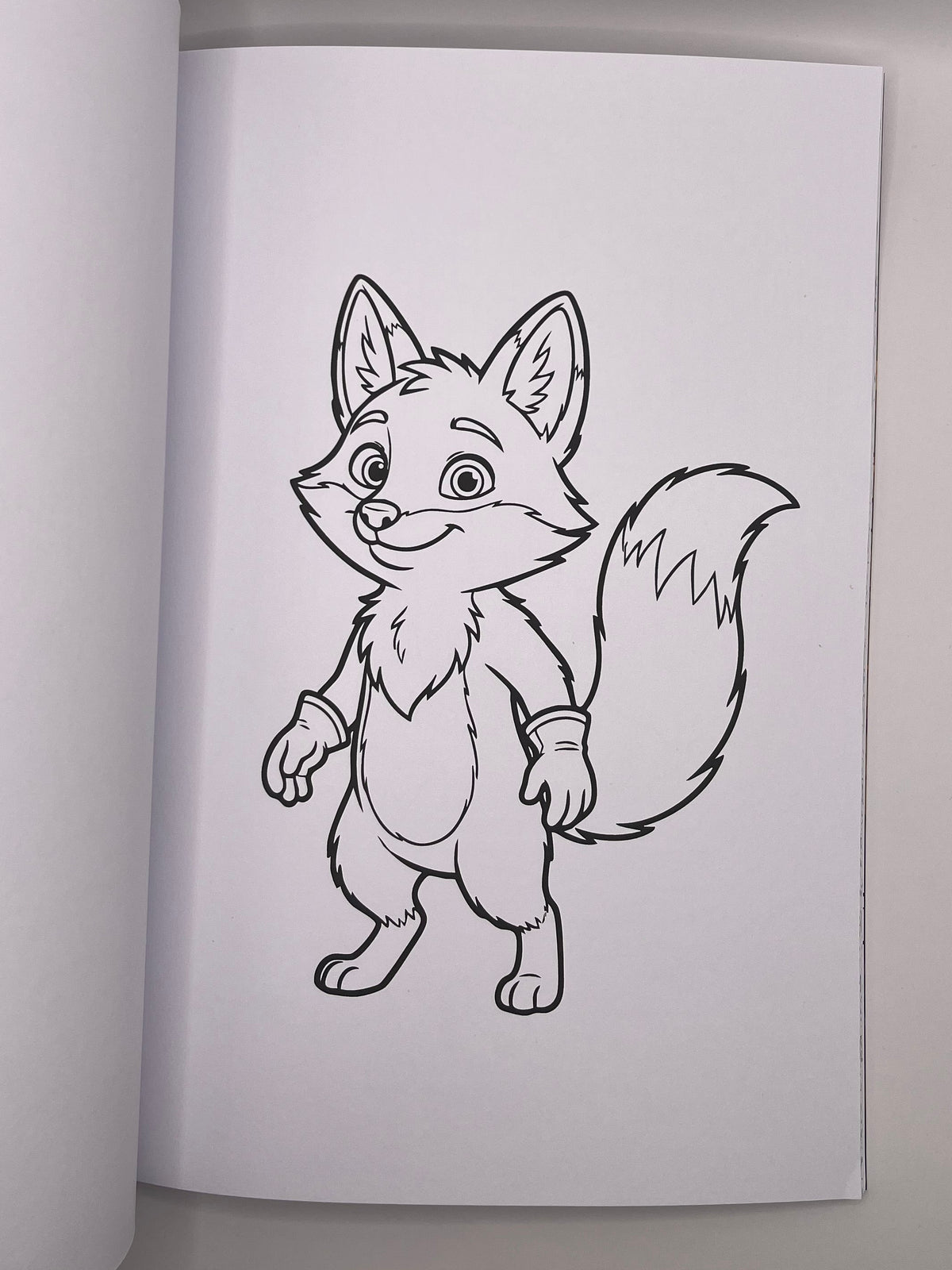 Colouring page with a smiling fox character