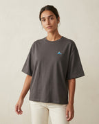 A woman wearing the 1800m Club Hörnli embroidered Boxy T-shirt designed in Arosa, Switzerland.
