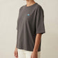 A woman wearing the 1800m Club Hörnli embroidered Boxy T-shirt designed in Arosa, Switzerland.
