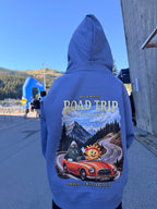 Ray & Monty Road Trip kids' hoodie worn outdoors with the hood up, showing the red convertible and Alpine road back print.